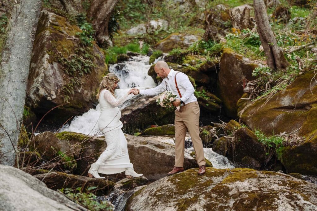 jumping over boulders weddings over waterfalls