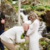 kissing belly at a waterfall with elope outdoors