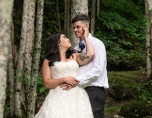 small wedding vs traditional wedding cost couple caressing in forest