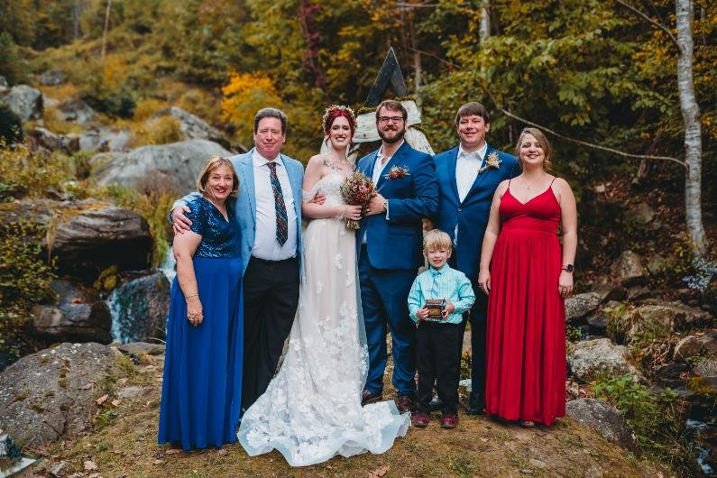 micro wedding cost in North Carolina couple with family at waterfall ceremony